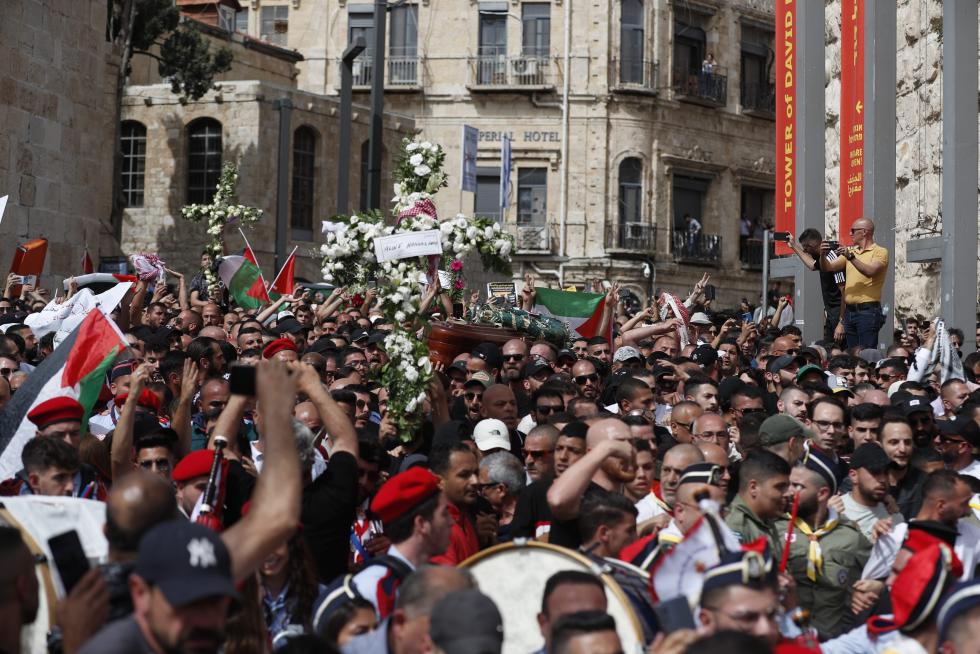 Family and friends carry the coffin of Al Jazeera reporter Shireen Abu Akleh, who was killed during an Israeli raid in Jenin in the occupied West Bank, during her funeral in a church in Jerusalem, May 13, 2022. REUTERS/Ammar Awad ISRAEL-PALESTINIANS/JOURNALIST