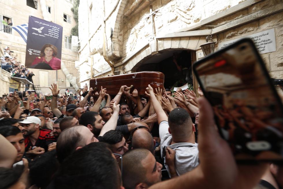 Family and friends carry the coffin of Al Jazeera reporter Shireen Abu Akleh, who was killed during an Israeli raid in Jenin in the occupied West Bank, during her funeral in a church in Jerusalem, May 13, 2022. REUTERS/Ammar Awad ISRAEL-PALESTINIANS/JOURNALIST