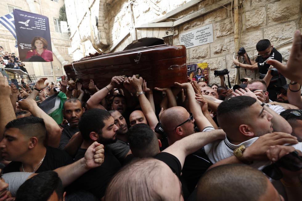Family and friends carry the coffin of Al Jazeera reporter Shireen Abu Akleh, who was killed during an Israeli raid in Jenin in the occupied West Bank, during her funeral in a church in Jerusalem, May 13, 2022. REUTERS/Ammar Awad ISRAEL-PALESTINIANS/JOURNALIST