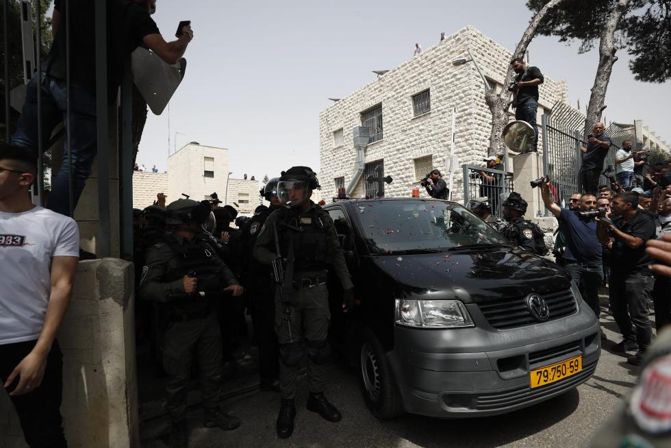 Family and friends carry the coffin of Al Jazeera reporter Shireen Abu Akleh, who was killed during an Israeli raid in Jenin in the occupied West Bank, during her funeral in a church in Jerusalem, May 13, 2022. REUTERS/Ammar Awad ISRAEL-PALESTINIANS/JOURNALIST
