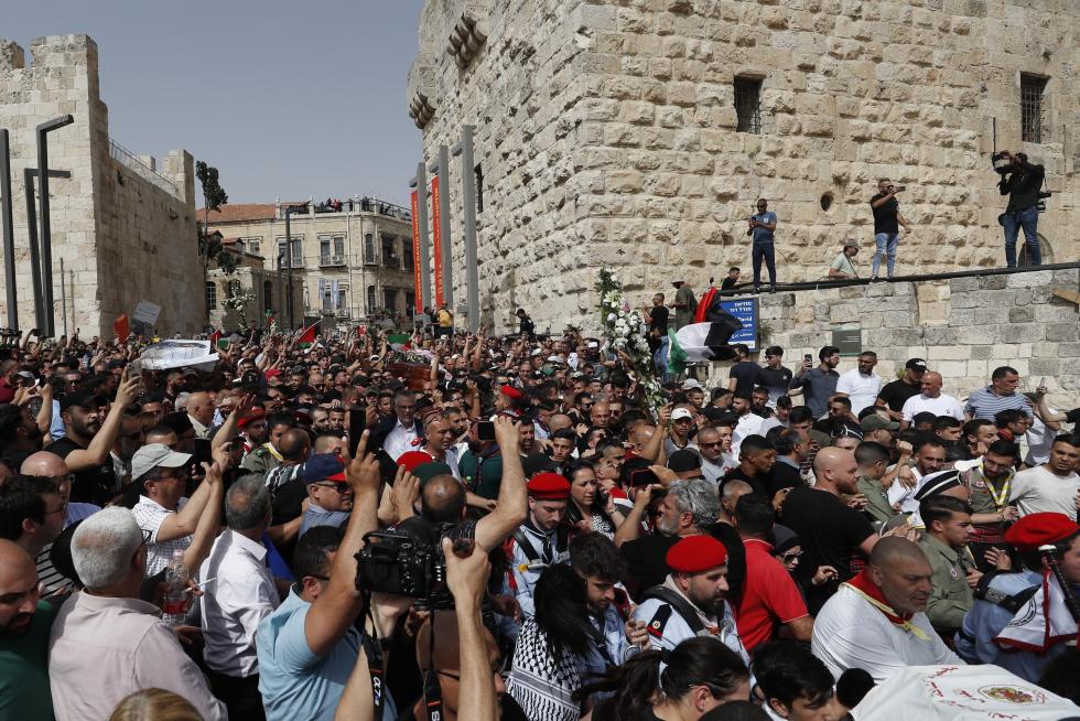 Family and friends carry the coffin of Al Jazeera reporter Shireen Abu Akleh, who was killed during an Israeli raid in Jenin in the occupied West Bank, during her funeral in a church in Jerusalem, May 13, 2022. REUTERS/Ammar Awad ISRAEL-PALESTINIANS/JOURNALIST