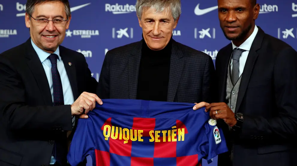 El presidente del FC Barcelona, Josep María Bartomeu (i), y el director deportivo, Eric Abidal (d), junto al nuevo entrenador del club, Quique Setién (c)