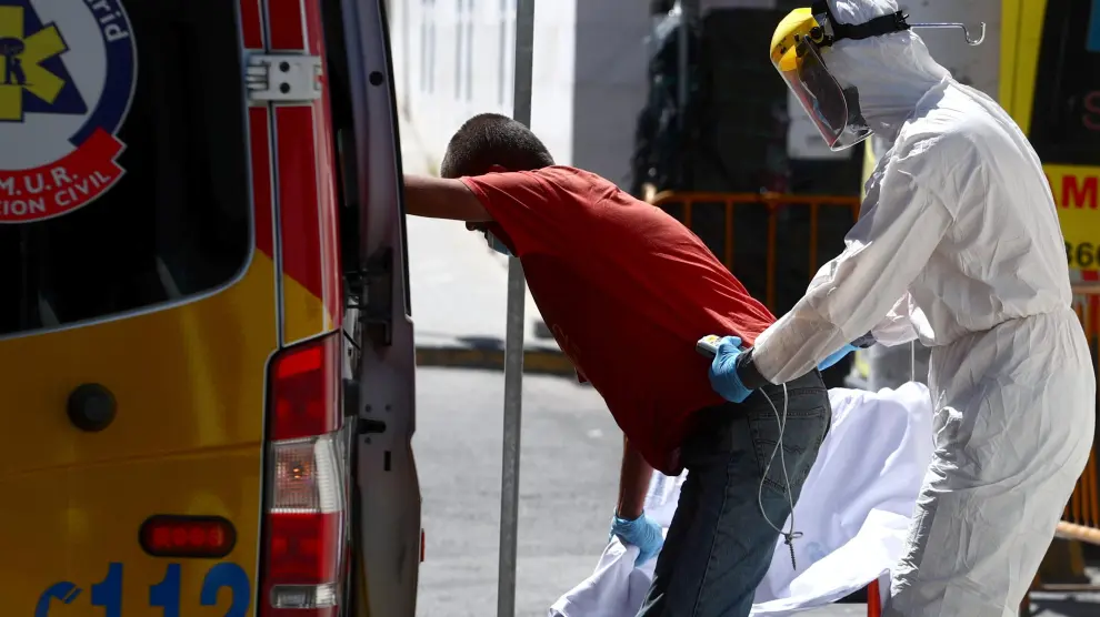 A health worker wearing personal protective equipment, arrives at the emergency unit at 12 de Octubre hospital in Madrid
