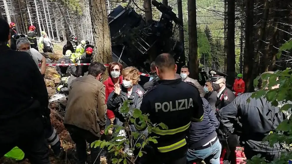 Police and rescue service members are seen near the crashed cable car after it collapsed in Stresa