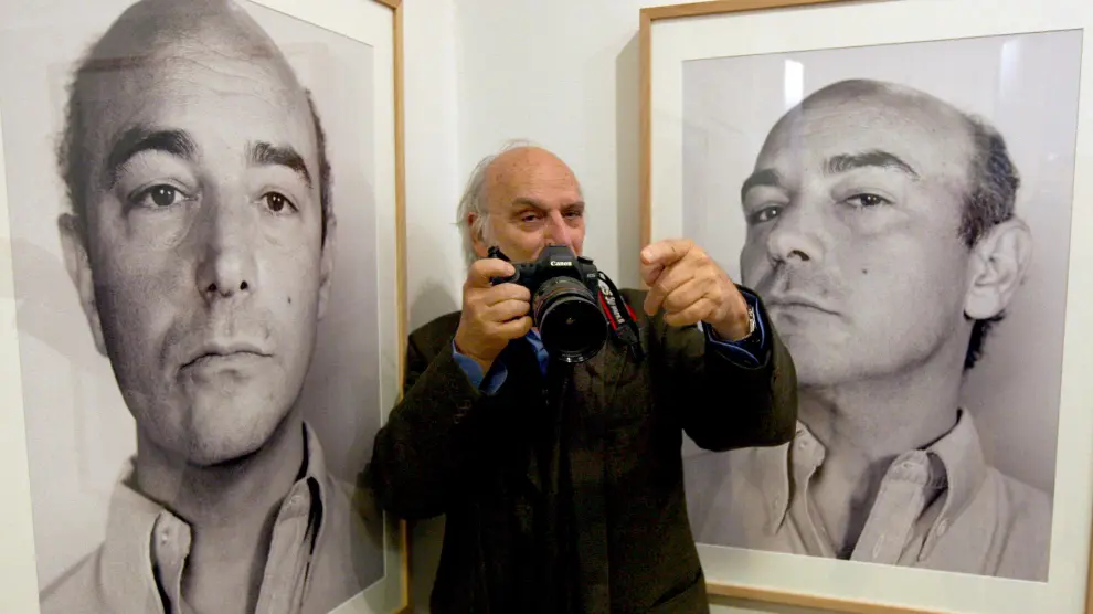 El cineasta Carlos Saura, junto a dos de las fotos de su hermano