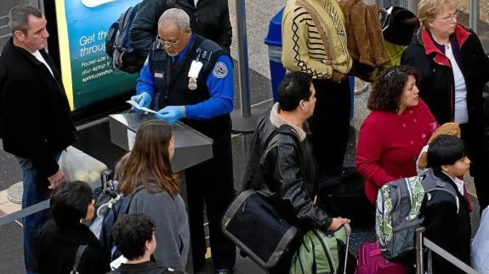 Un agente identifica a los pasajeros, ayer, en el aeropuerto Ronald Reagan de Washington.