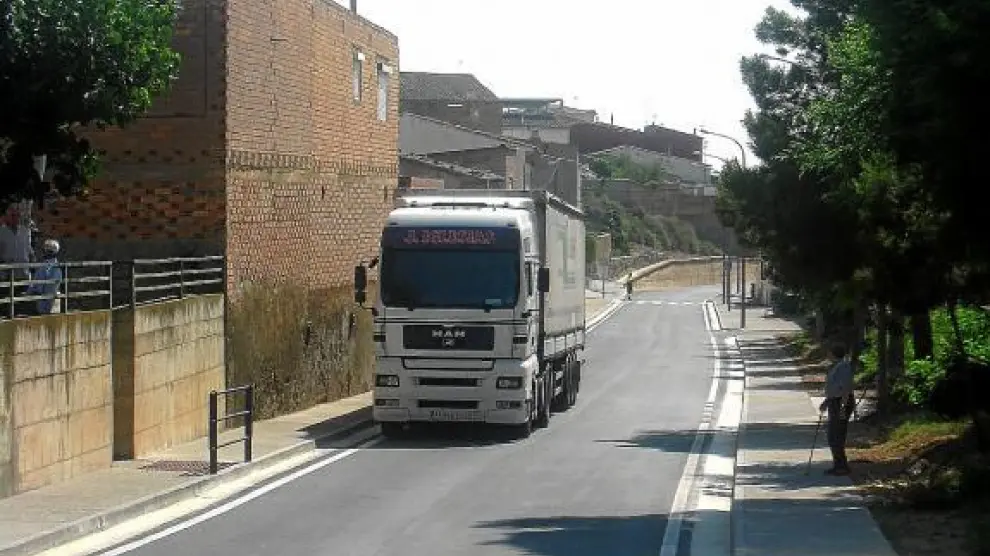 Uno de los primeros vehículos que transitó ayer por la renovada travesía de Ontiñena.