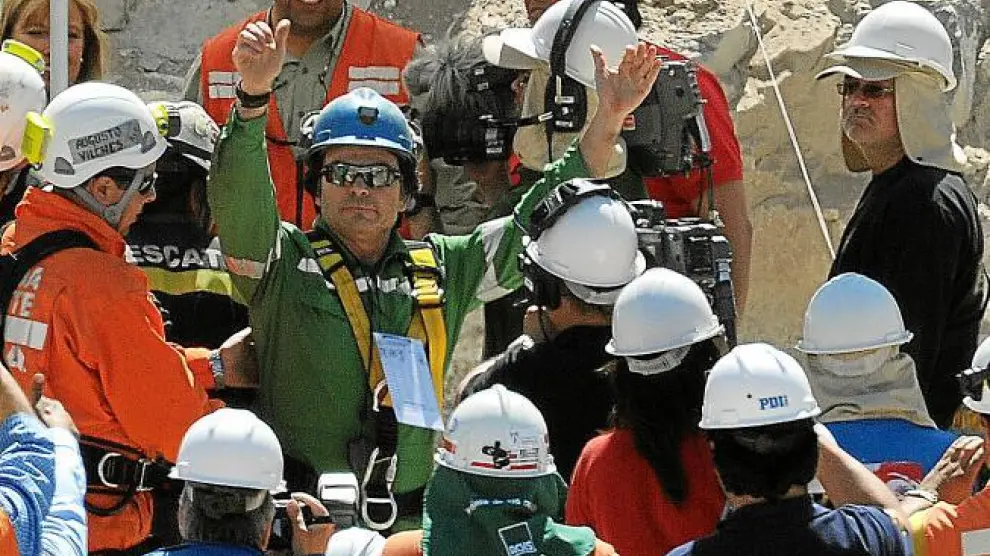 El minero Pablo Rojas levanta los brazos en señal de victoria después de ser rescatado de la mina.