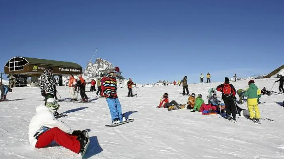 Varios esquiadores y 'surferos', ayer, en la estación de Formigal, junto al telesilla de Batallero.