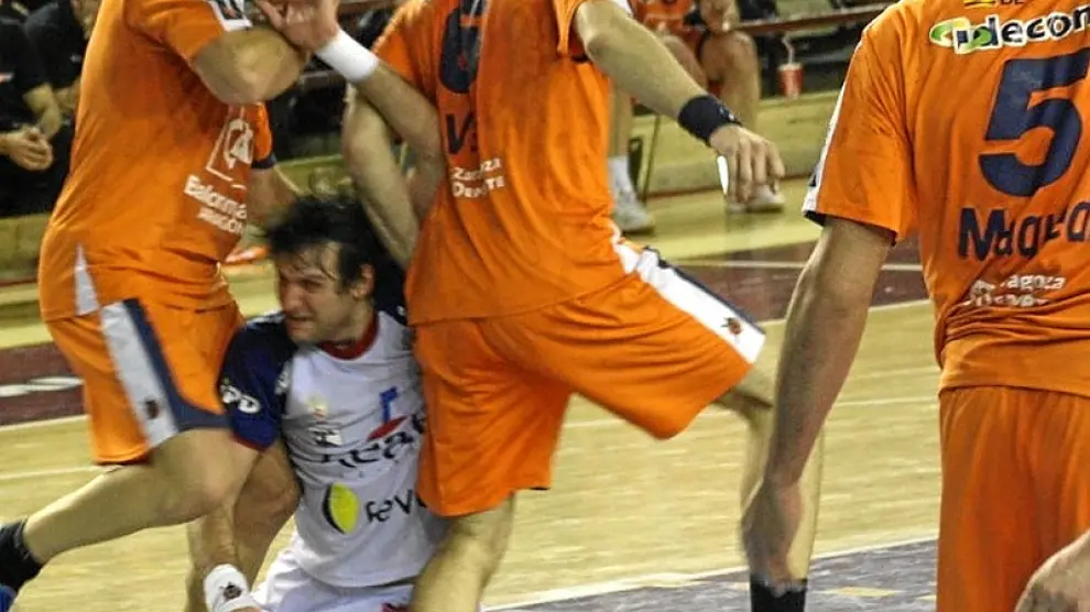 Demetrio Lozano y Alberto Val en plena acción defensiva ante el pivote Carou.