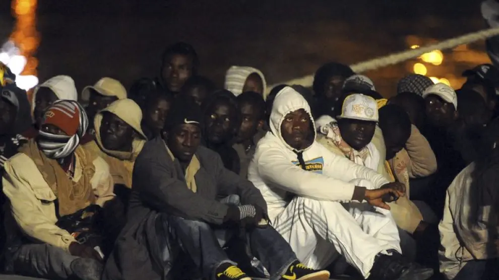 Un grupo de inmigrantes africanos en el muelle de la Isla italiana de Lampedusa