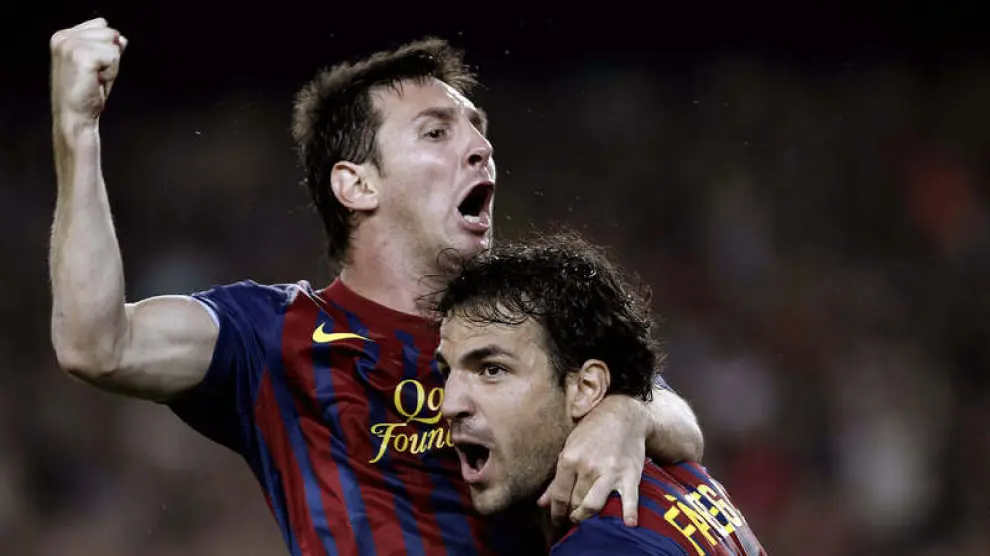 El centrocampista del FC Barcelona Cesc Fábregas (d) felicita al argentino Leo Messi tras marcar el tercer gol ante el Real Madrid