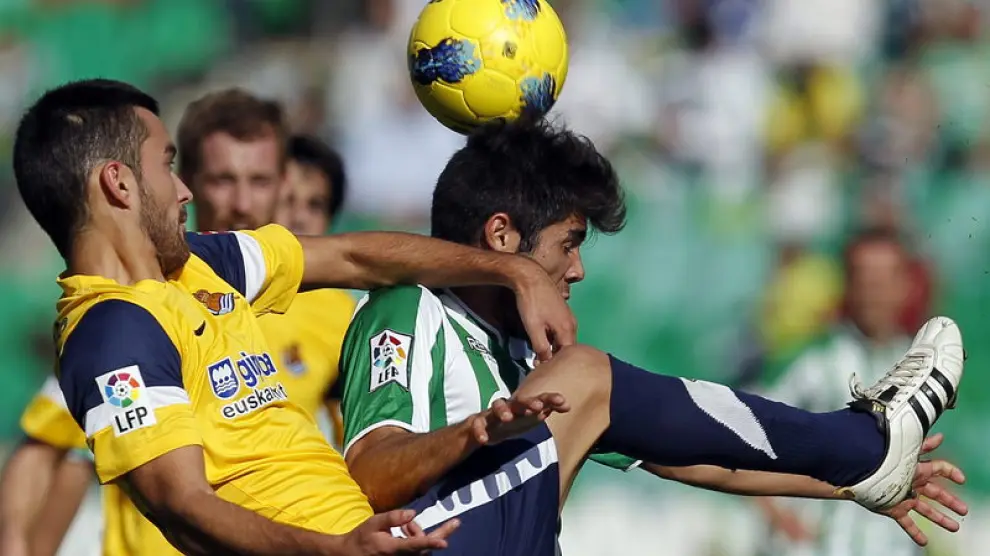 El jugador del Real Betis Pozuelo (d), y Estrada (i), de la Real Sociedad