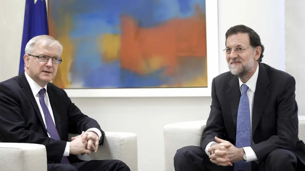 Olli Rehn y Mariano Rajoy