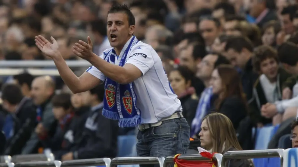 Un seguidor del Real Zaragoza anima al equipo en las gradas de La Romareda