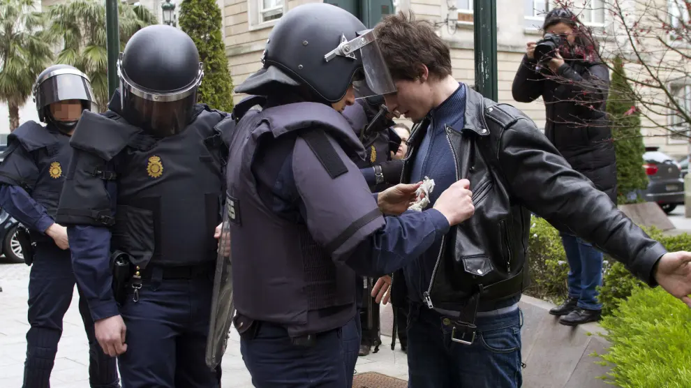 Varios policías registran a un joven durante la manifestación contra la LOMCE