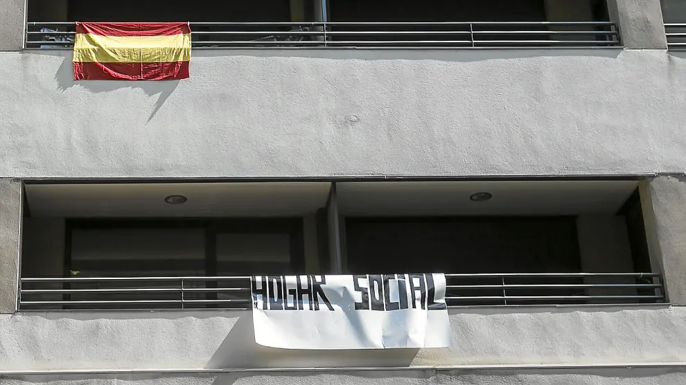Una bandera de España y un cartel que anuncia el "hogar social" colgaban ayer de la fachada del edificio, en Compromiso de Caspe.