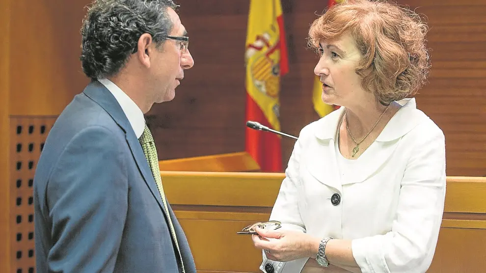 Pilar Molinero habla con Joaquín Períbañéz (PAR) antes de comparecer ayer en las Cortes.