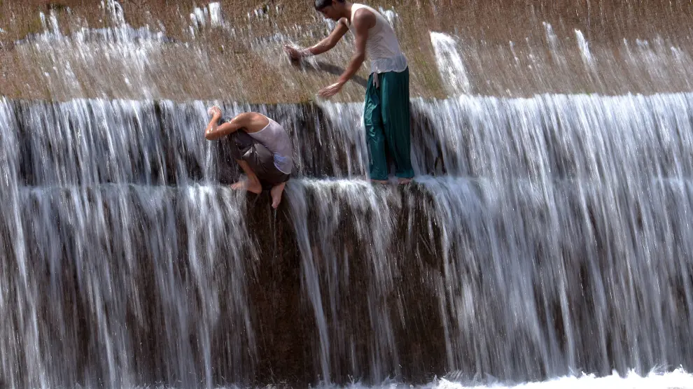 Dos jóvenes paquistaníes se refrescan durante la ola de calor