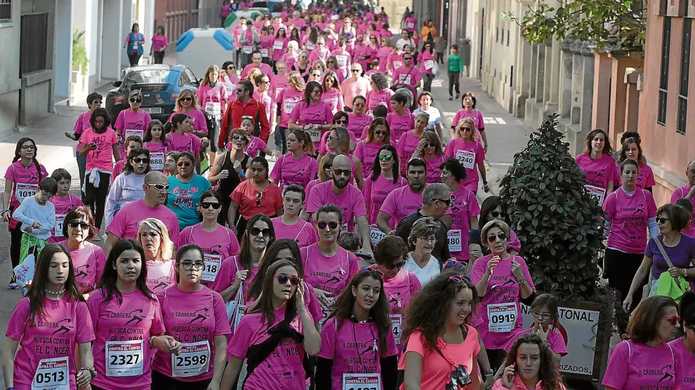 Cientos de oscenses completaron el recorrido de la prueba corriendo o caminando, llenando las calles de Huesca de solidaridad.