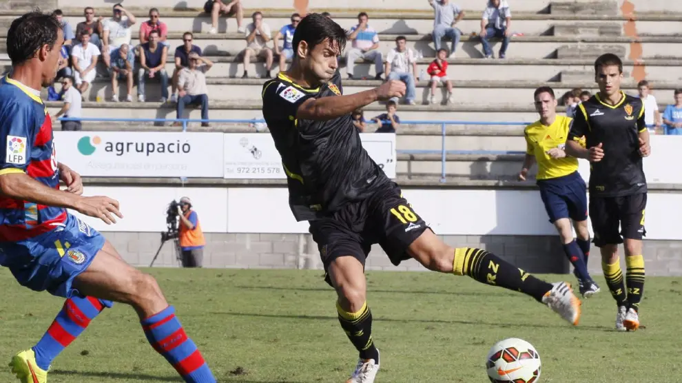 Dorca, con Ruiz de Galarreta al fondo, pelea un balón con un jugador del Llagostera en el partido de la pasada temporada en Palamós. El Real Zaragoza vistió de negro con detalles amarillos.