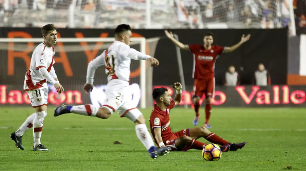 Ángel, caído en el suelo tras perder el balón ante el rayista Fran Beltrán, mientras Cabrera pide falta al fondo, en un lance del partido Rayo Vallecano-Real Zaragoza que ganó el cuadro aragonés 1-2 el pasado domingo.