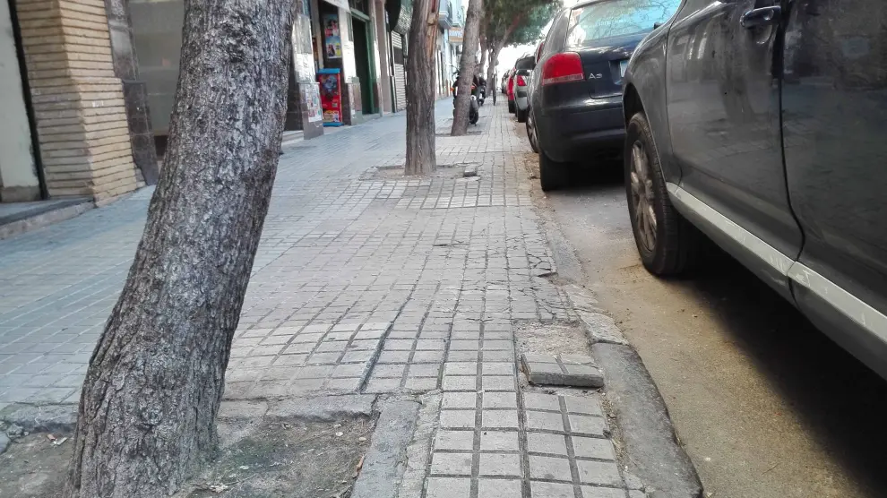 Desniveles, baldosas levantadas y bordillos hundidos, en la calle de Ricla de Zaragoza.