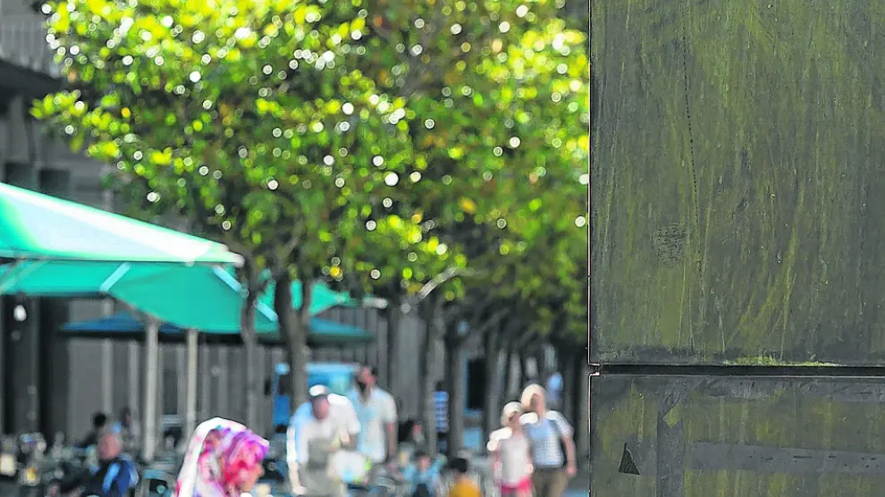 Una ciudadana observa el móvil en la zona Wizi de la plaza del Pilar.