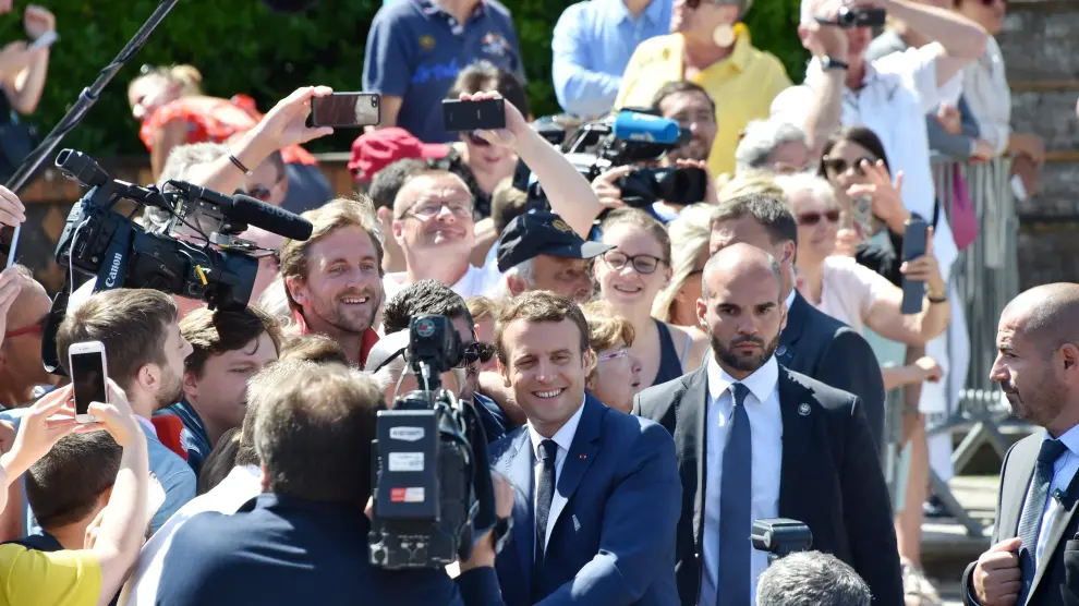 El presidente francés Emmanuel Macron saluda a la gente durante la jornada electoral