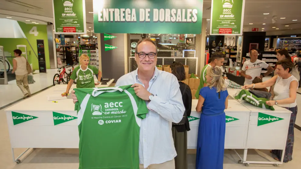 César Pérez posa con una de las camisetas de la Marcha contra el Cáncer.