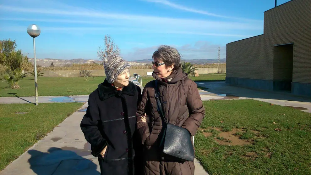 Blanca Bueno, de 86 años y enferma de alzhéimer, pasea del brazo de su hija Carmen, ya jubilada.