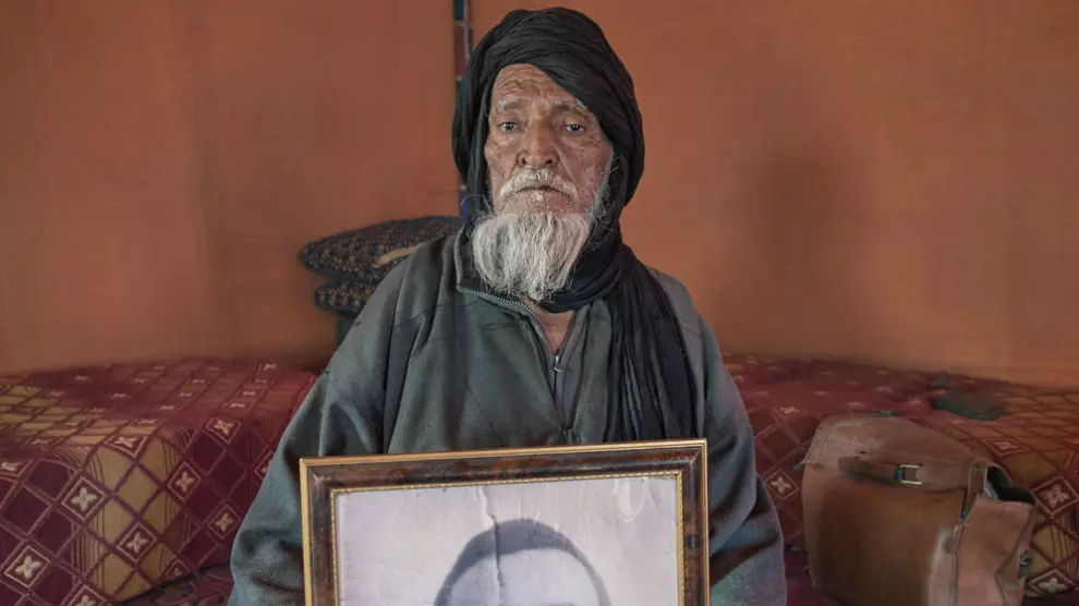 Mohamed Malainin Ali, nacido en 1927, muestra el retrato de su hijo Zaid Mohamed Malainin, detenido en 1976 por gendarmes marroquíes cuando tenía 31 años y llevado a la prisión de Smara.