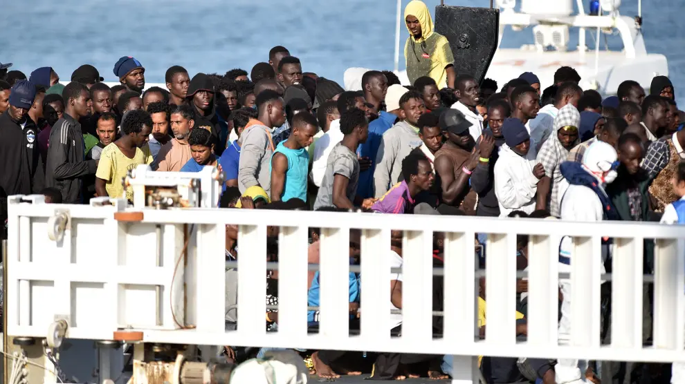 Los inmigrantes esperan en el barco a poder desembarcar en el puerto siciliano