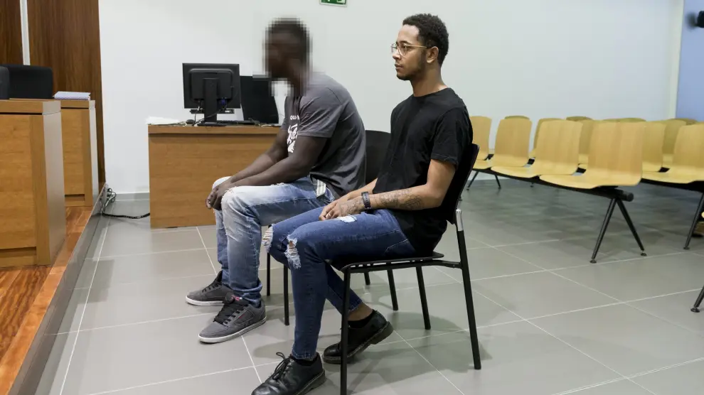 El acusado, con gafas, durante el juicio celebrado el pasado mes de julio en la Audiencia de Zaragoza. El otro joven, junto a él, ha sido absuelto.
