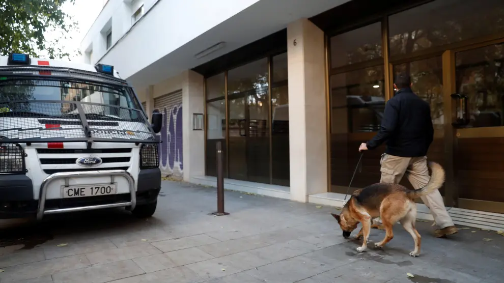 Un vehículo de los mossos, ante uno de los edificios de Barcelona que han sido registrado.