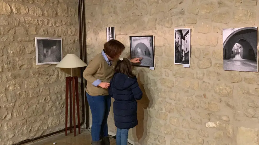 Varios visitantes contemplan algunas de las fotografías que forman parte de esta muestra.