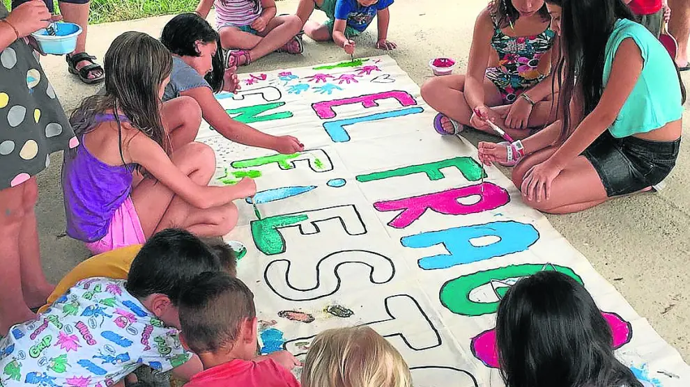 Los niños fueron los encargados de pintar una gran pancarta para recibir a los visitantes.
