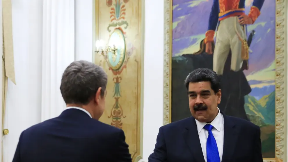 Fotografía cedida por la oficina de prensa de Miraflores donde se observa al presidente de Venezuela, Nicolás Maduro (d), recibir al expresidente del Gobierno español José Luis Rodríguez Zapatero (i) este viernes, en Caracas