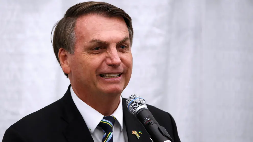 Brazilian President Jair Bolsonaro smiles as he speaks during a meeting with the Brazilian community at The Miami Dade College Auditorium, in Miami