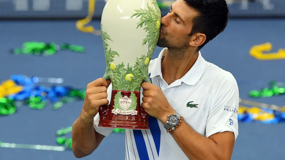 El campeón Novak Djokovic posa con el trofeo tras la victoria frente al canadiense Milos Raonic.