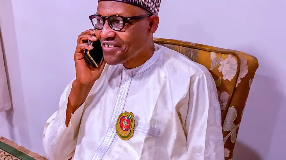 Nigerian President Muhammadu Buhari speaks on the phone with Katsina state Governor Aminu Bello Masari