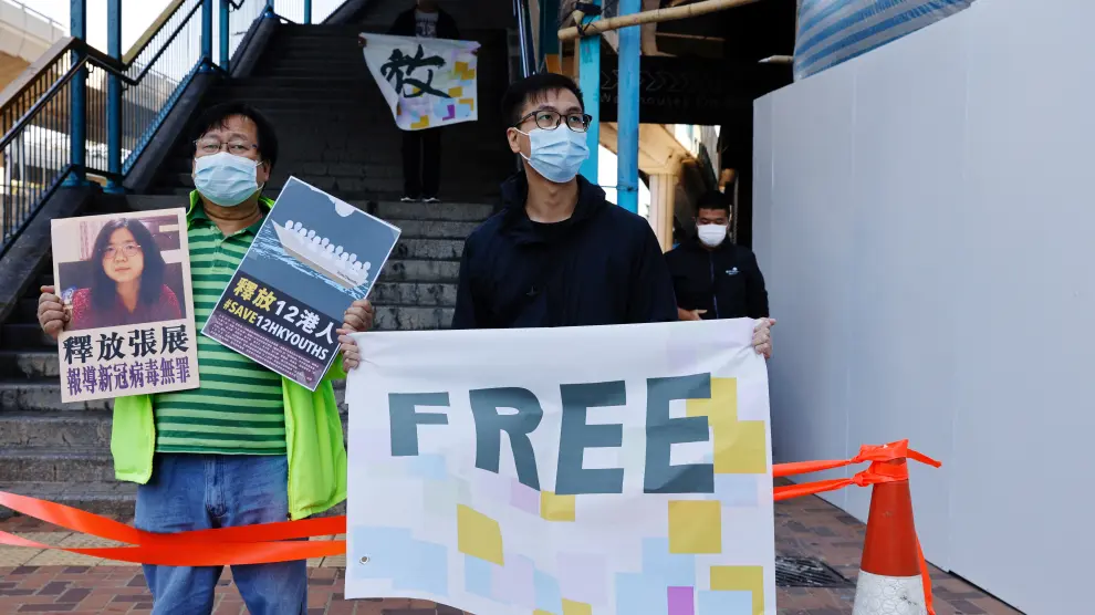 Pro-democracy supporters protest to urge for the release of 12 Hong Kong activists arrested as they reportedly sailed to Taiwan for political asylum and citizen journalist Zhang Zhan outside China's Liaison Office, in Hong Kong