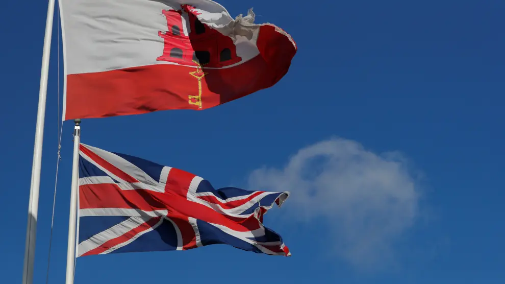 The Gibraltarian and Britain's Union Jack flags fly at the border of Spain with Gibraltar