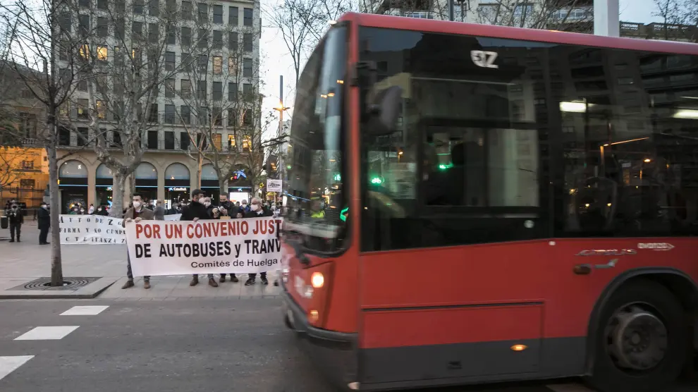 Un bus urbano pasa junto a una concentración de protesta del comité de empresa.