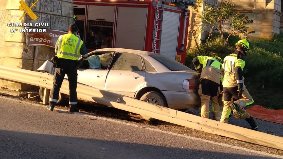 Efectivos de Guardai Civil y Bomberos, con el coche siniestrado cuyo conductor ha muerto en Albelda.