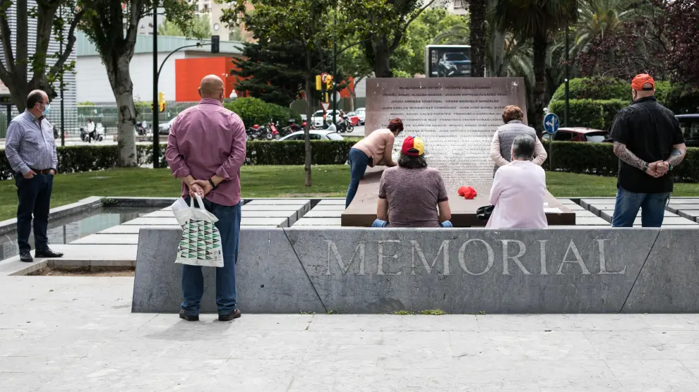 Varios familiares y compañeros de los fallecidos en el Yak llevan ramos de flores en el monumento del paseo de Constitución.