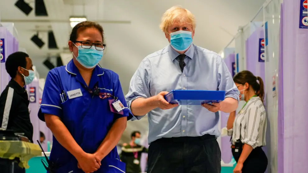 Britain's Prime Minister Boris Johnson visits a vaccination centre at the StoneX Stadium in London