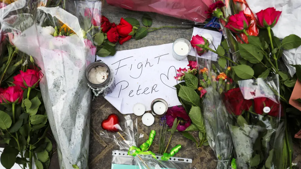 People leave flowers where Dutch crime reporter de Vries has been shot and reported seriously injured in Amsterdam