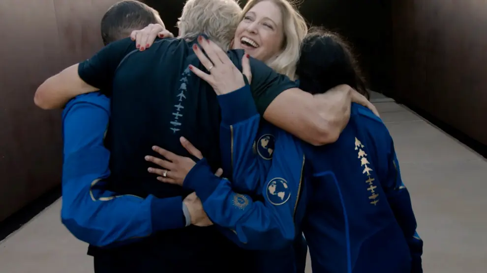 Virgin Galactic's chief astronaut instructor Beth Moses embraces Richard Branson at Spaceport America
