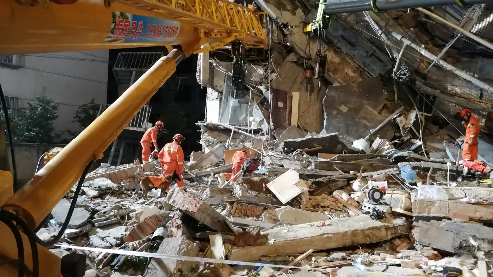 Rescue workers work at the site where a hotel building collapsed in Suzhou, Jiangsu